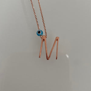 Minimalist letters with evil eye charm